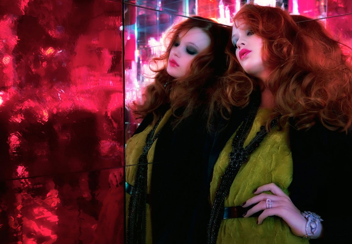 Fashion campaign portrait against red mirrored wall