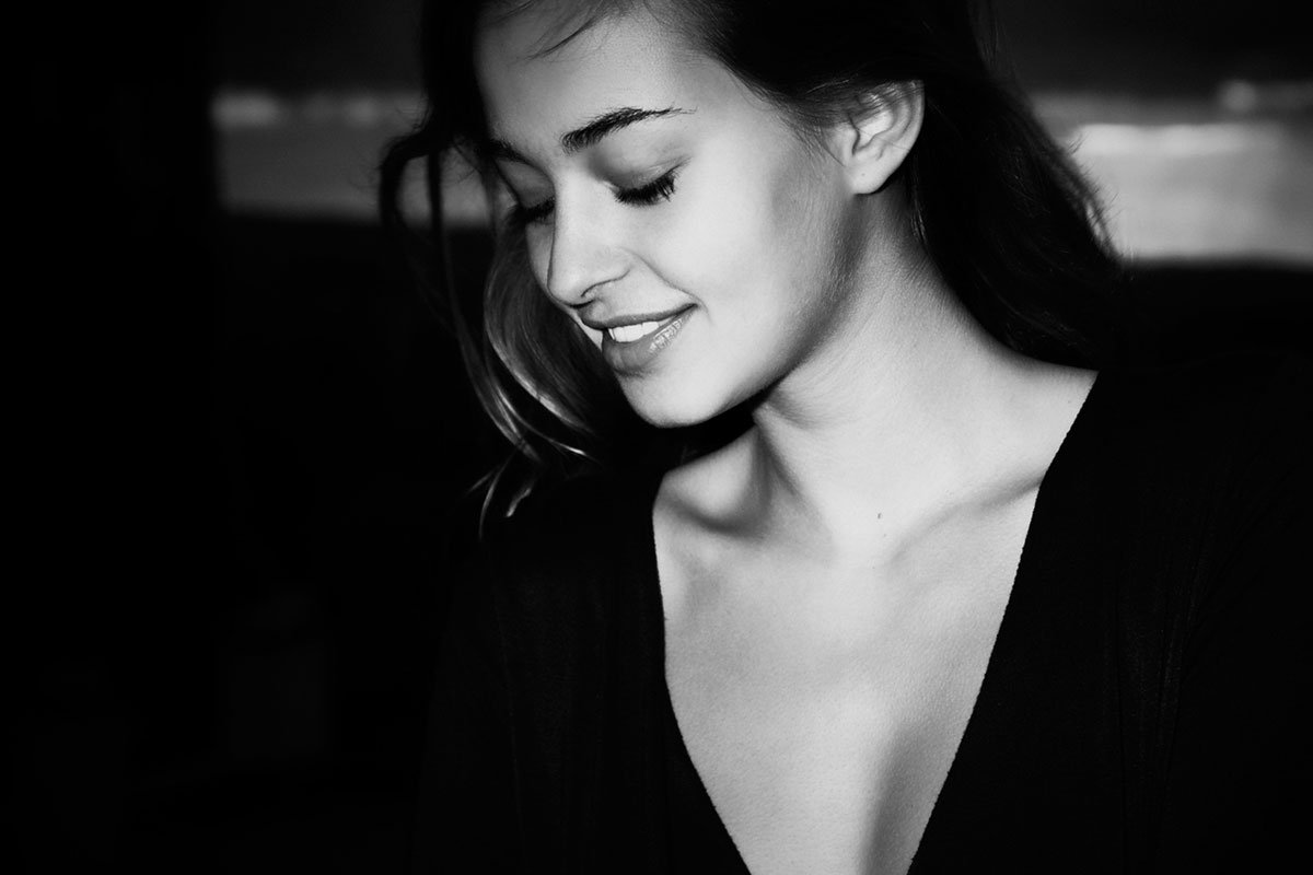 Black and white candid portrait, soft smile
