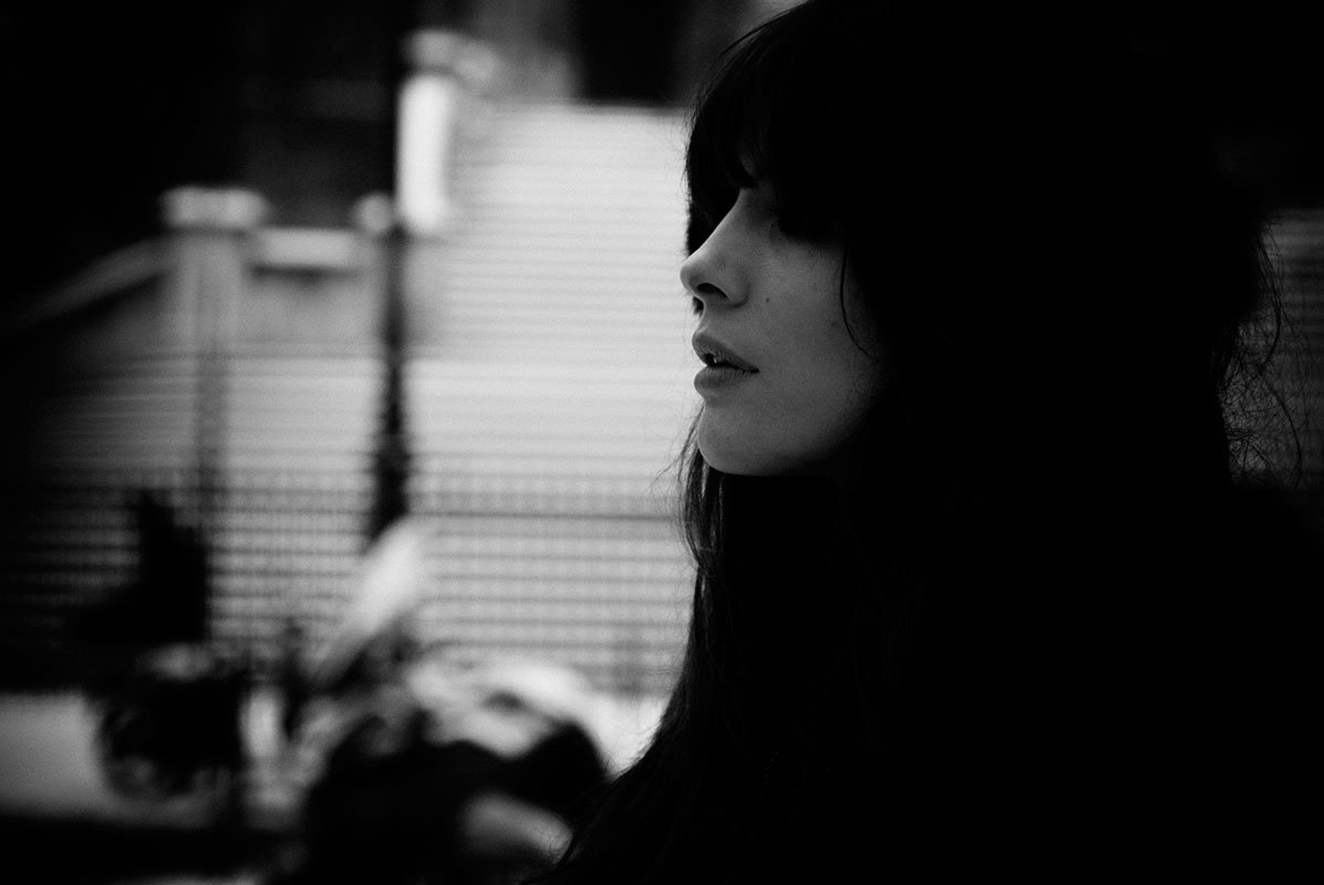 Black and white profile portrait against a window
