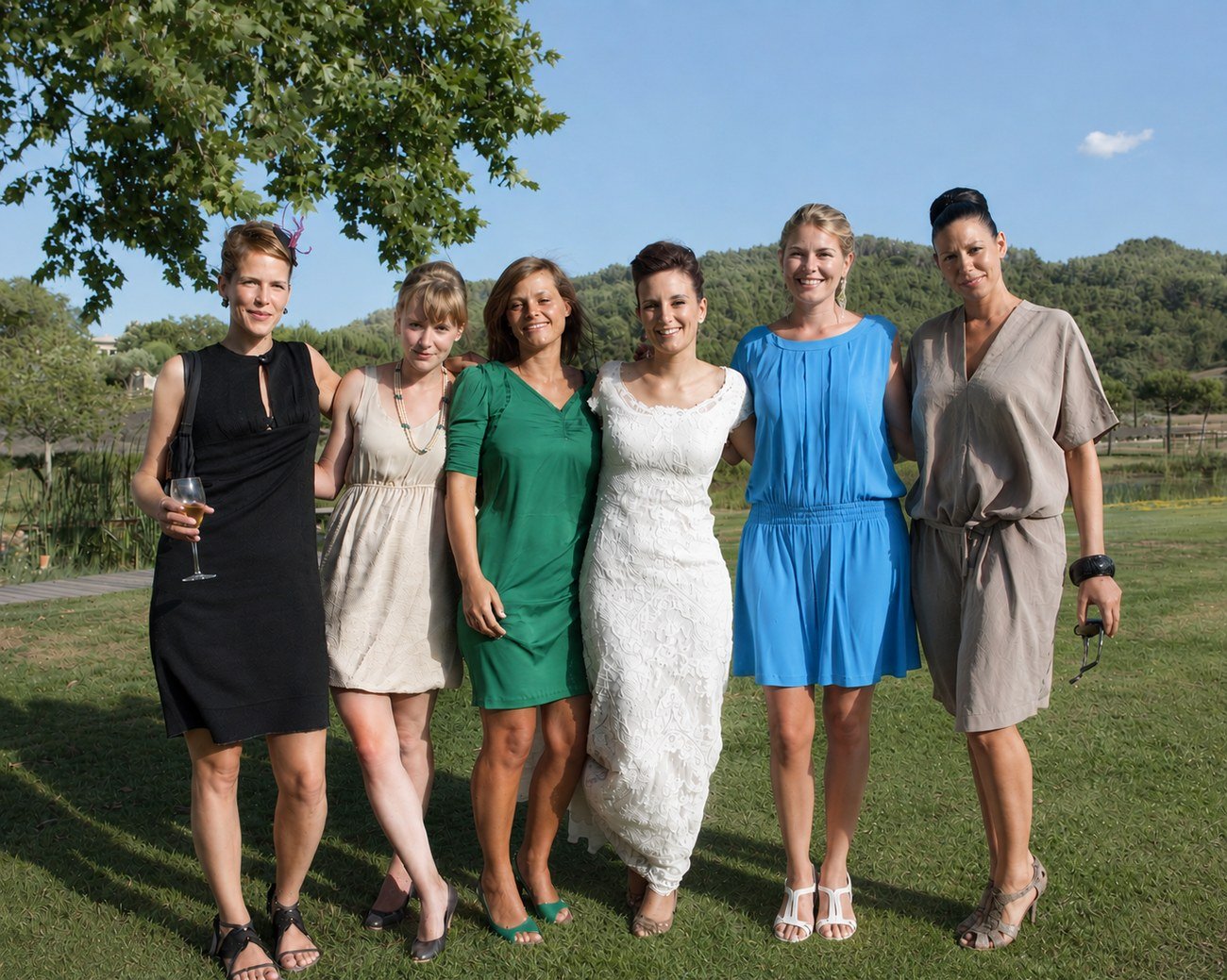 Bride with her bridesmaids on the lawn